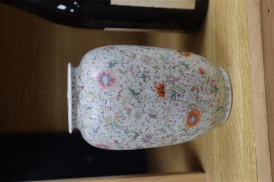 A Chinese famille rose ovoid vase, Qing dynasty, finely painted with flowers and scrolling foliage, H. 15cm, drilled hole to side of ba